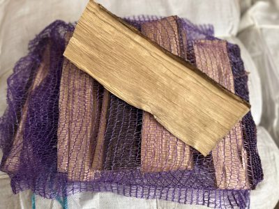 Dry split firewood in a net